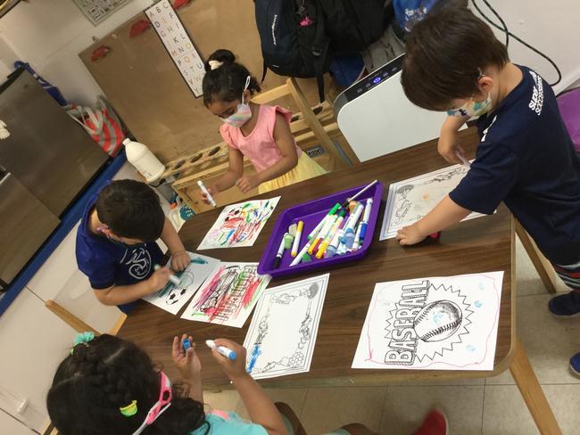On "Favorite Sports Team Day," children in the Little Dolphins Group at 76th Street colored in sports-themed pictures during Choice Time.