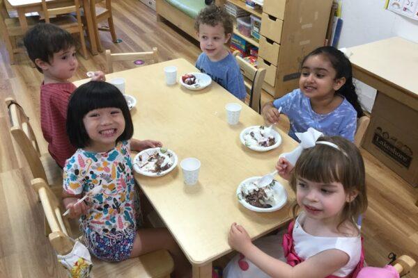 Green Room kids enjoying ice cream sundaes at snack time on the last day of school!