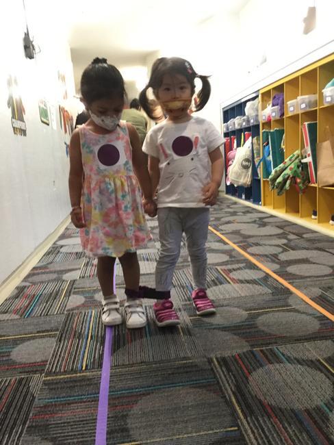 Friends work together during IPS Summer Camp's three-legged race at our 86th Street location.