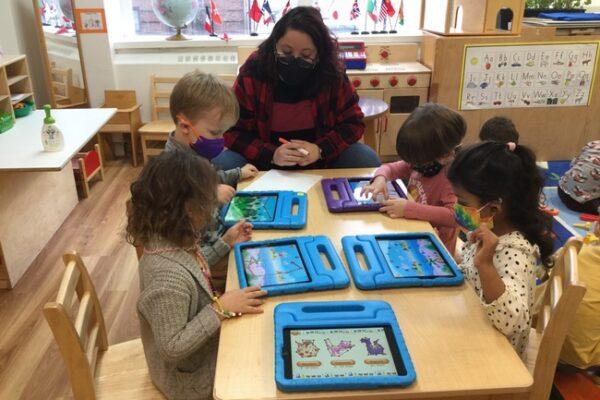 The Green Room children strengthen their math skills during technology class.