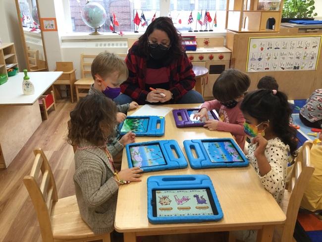 The Green Room children strengthen their math skills during technology class.