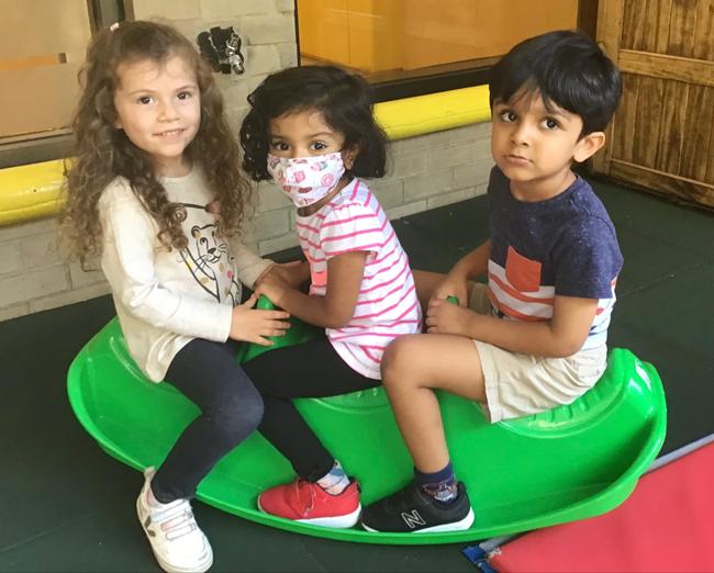 The International Preschool: Two Become One 2 Pre-K students enjoying their time on the front yard during the first days of school.