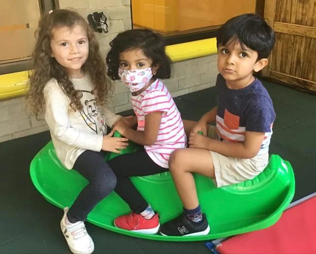 The International Preschool: Two Become One 2 Pre-K students enjoying their time on the front yard during the first days of school.
