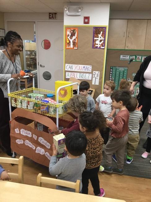 The Green Room children place their food donations into our City Harvest NYC basket.